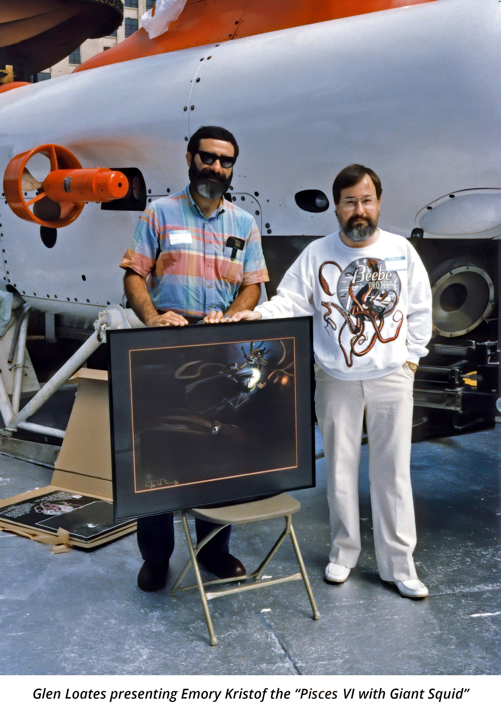 Glen Loates presenting Emary Kristof his painting titled "Pieces VI with Giant Squid"