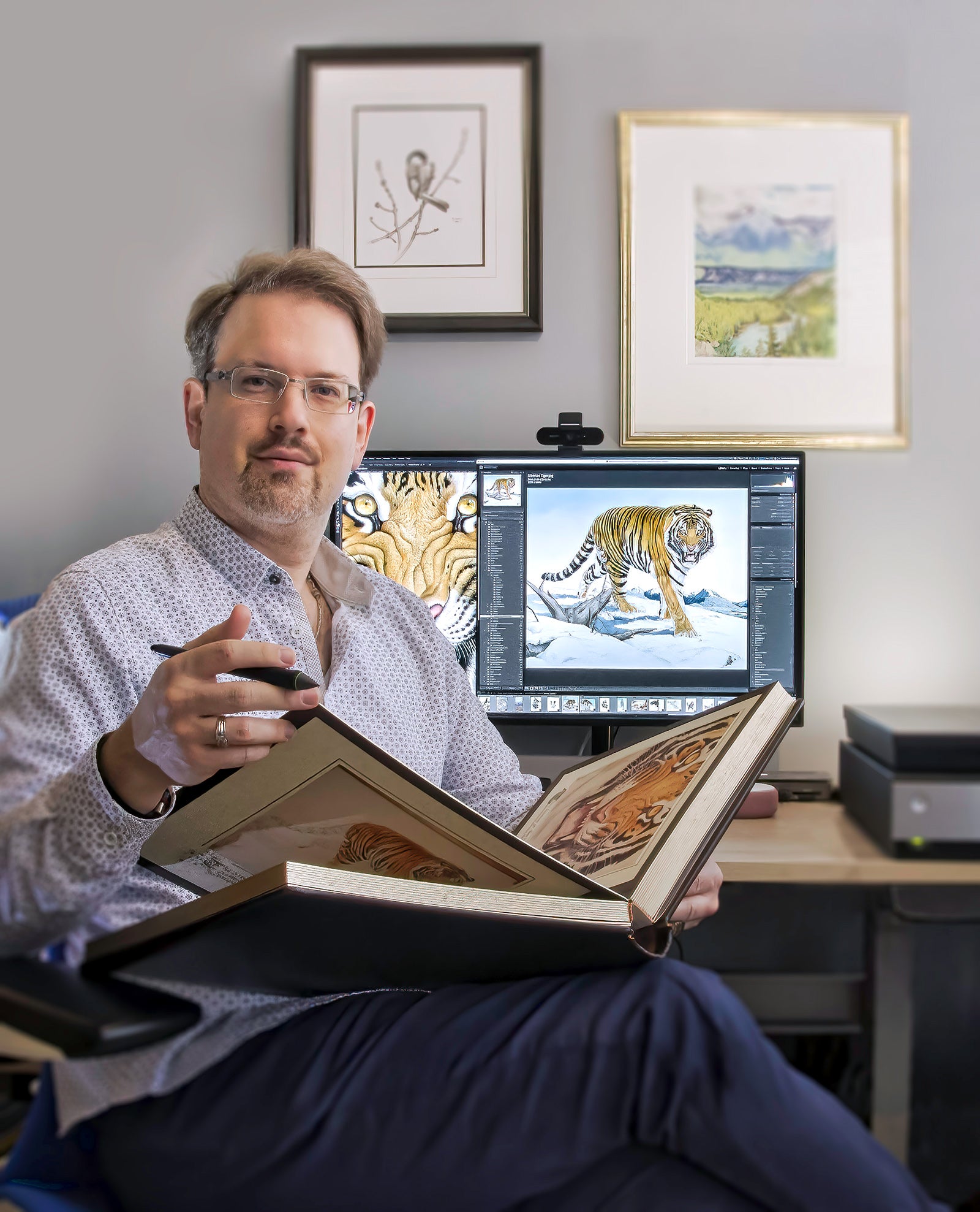 Michael Loates founder of The Glen Loates Store with the Siberian Tiger Book by Canadian nature artist, Glen Loates